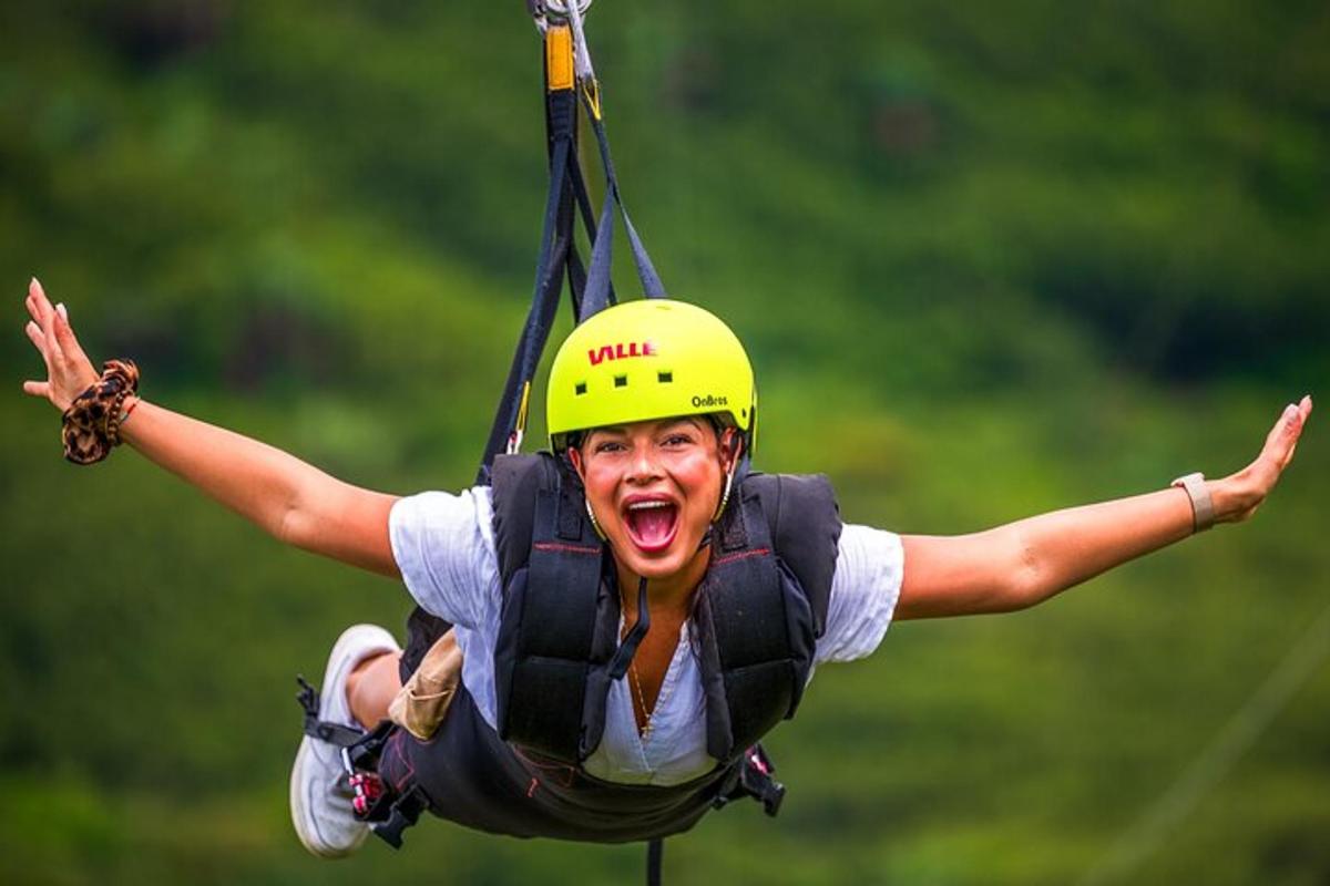 a woman in a helmet is on a zip line