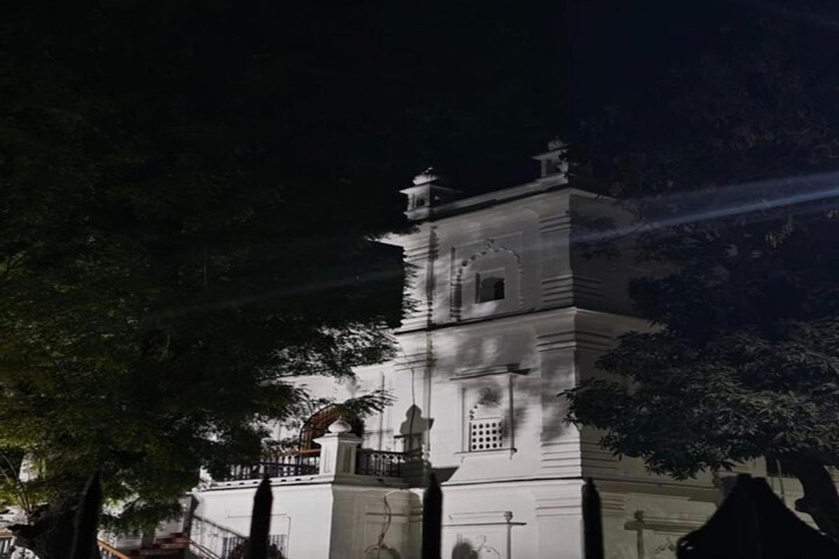 a white building with a clock tower at night