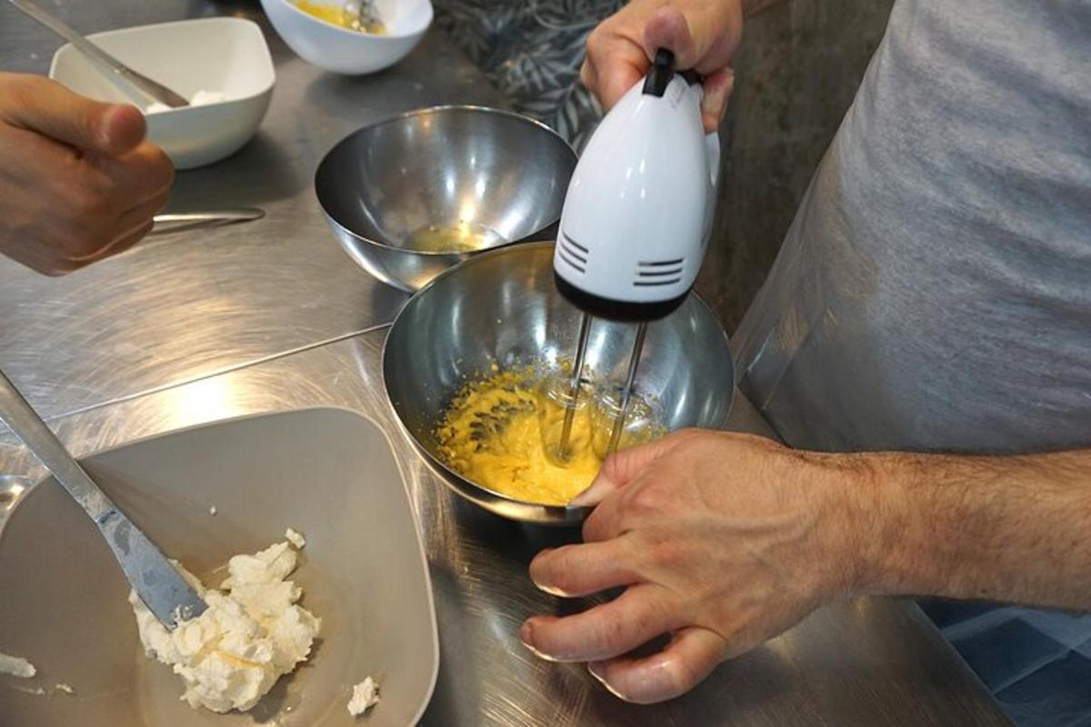 a person mixing food in a bowl with a mixer
