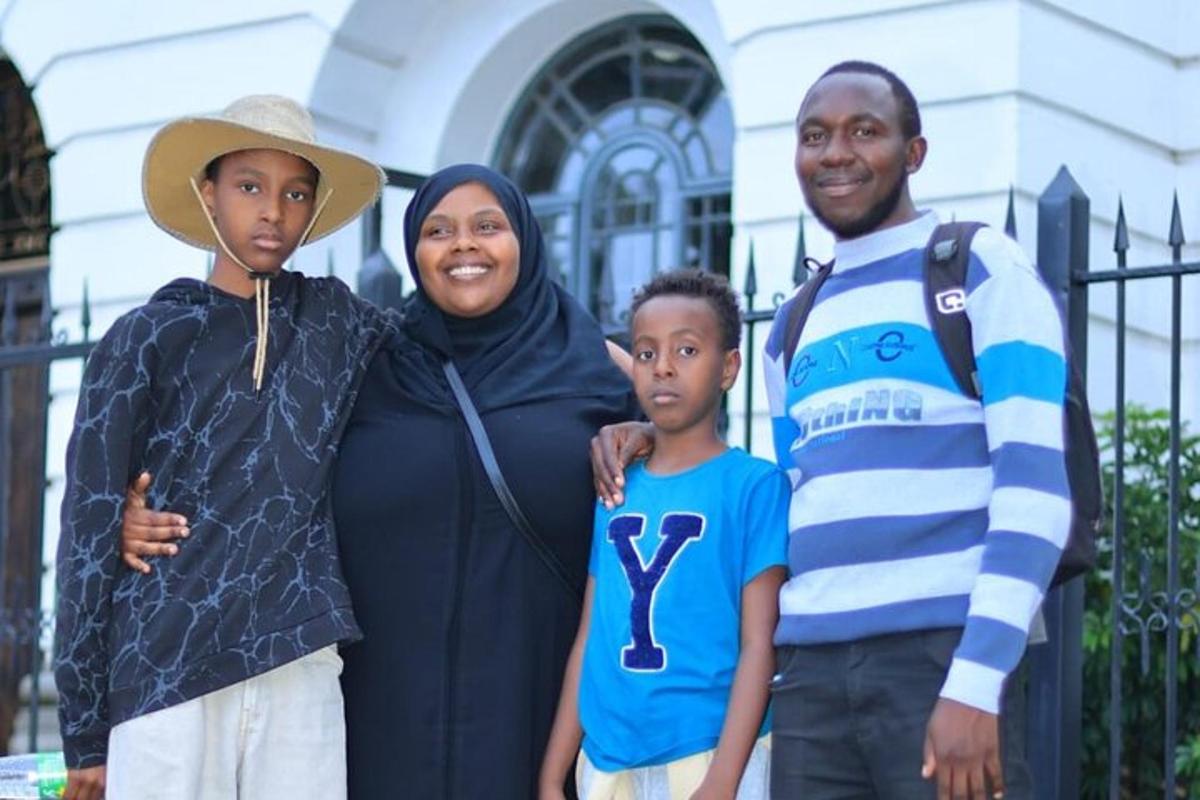 a family posing for a picture in front of a building