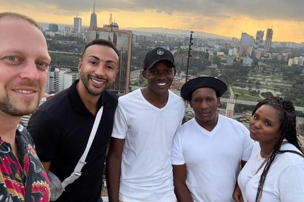 a group of people posing for a picture on top of a building
