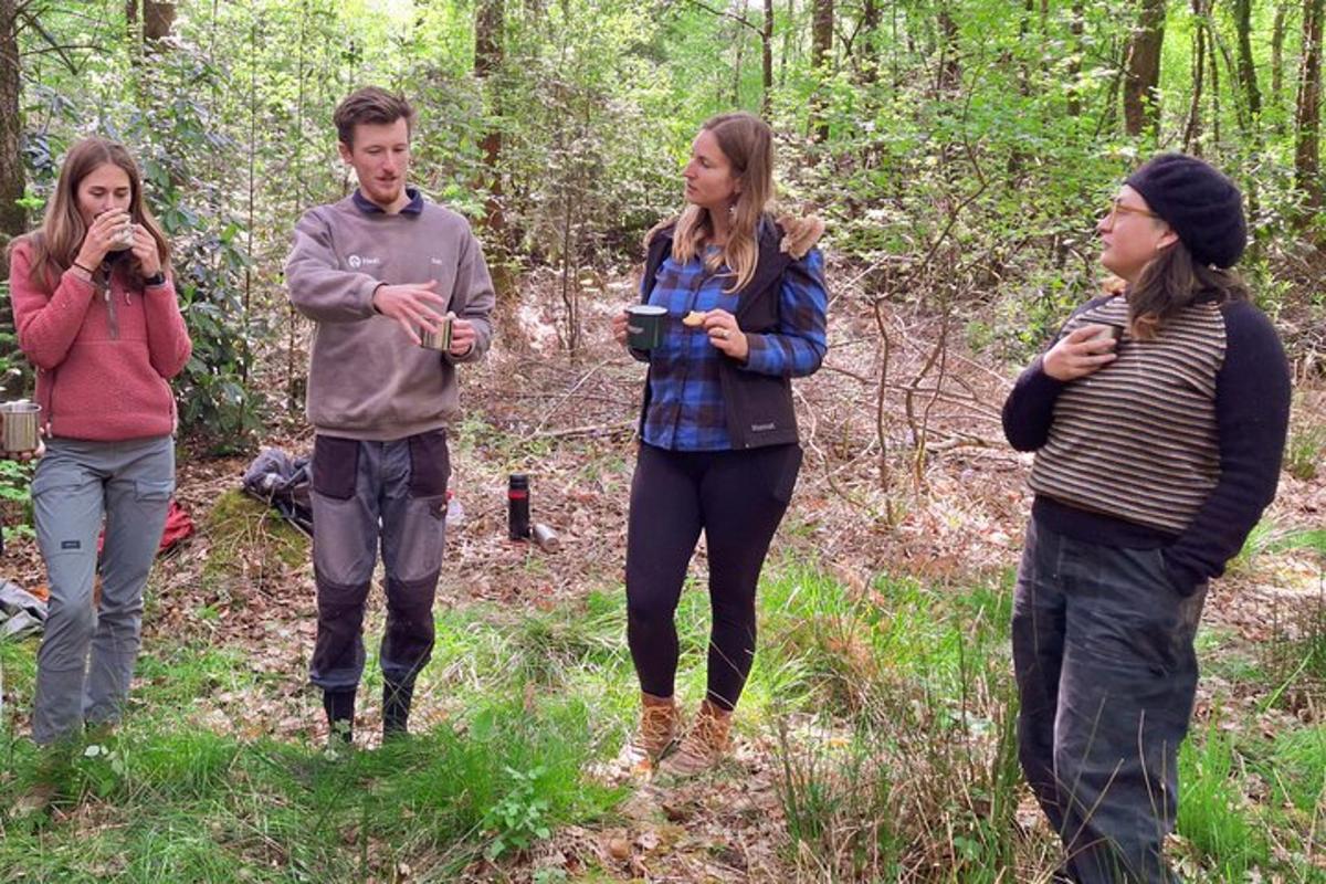 a group of people standing in the woods
