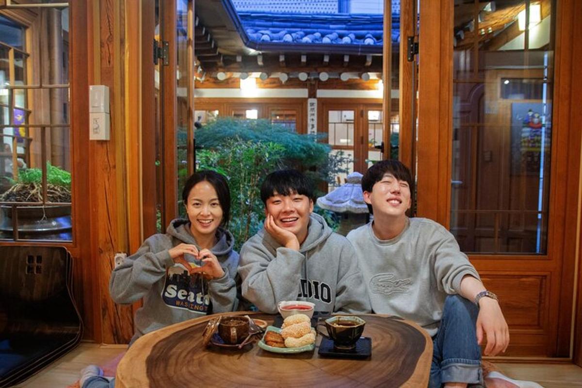 a group of three people sitting around a table