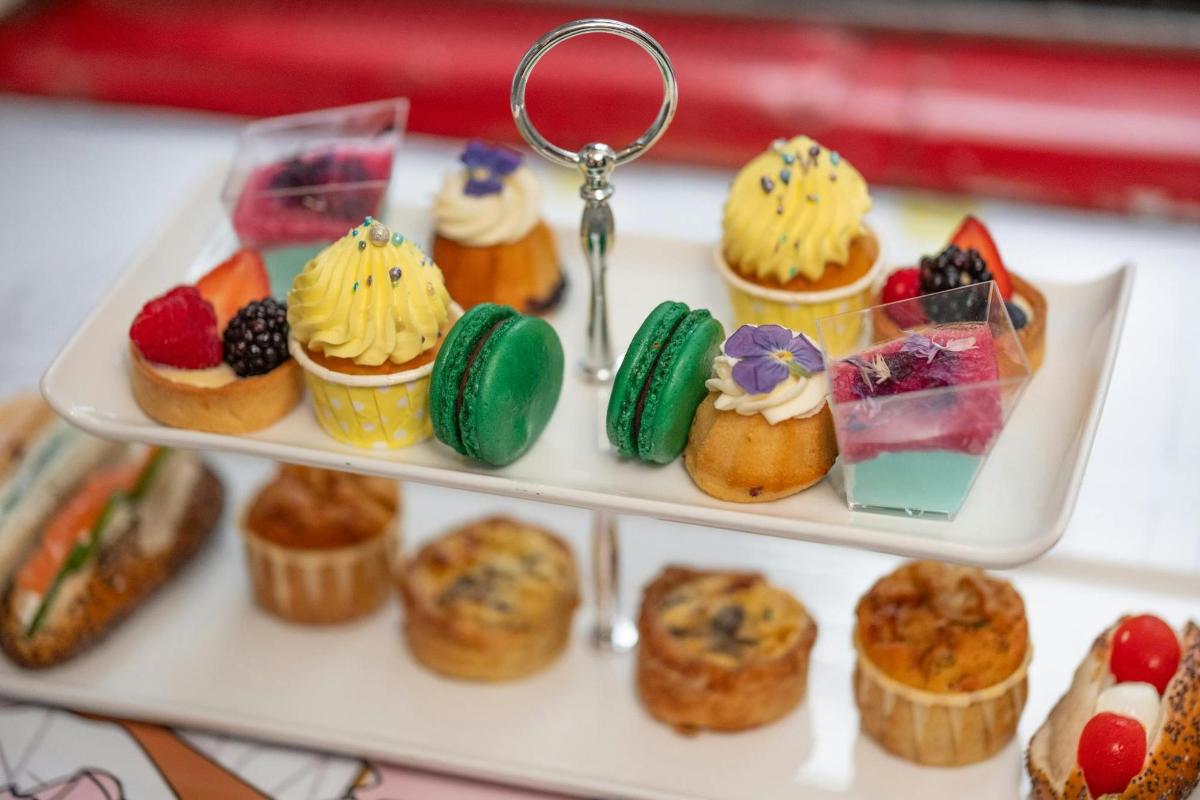 a tray of cupcakes and muffins on a table