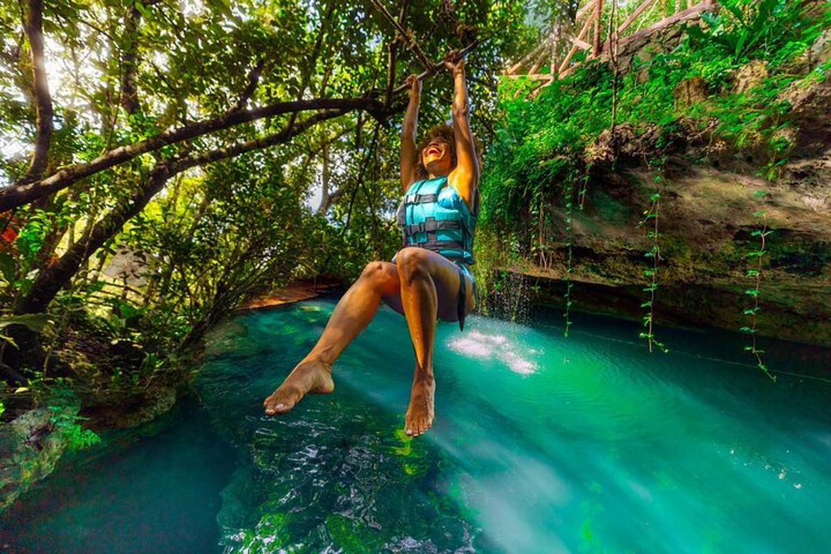 a person is hanging from a tree over a river