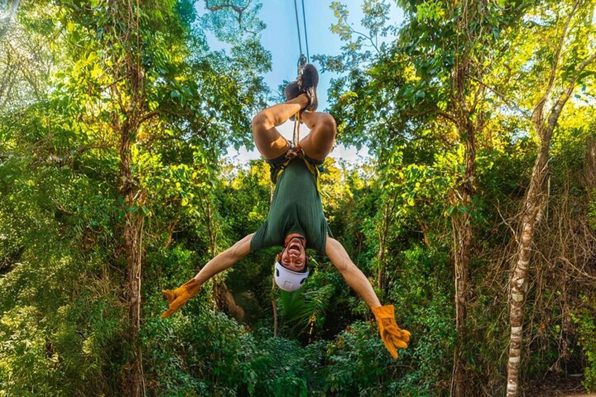 a man is suspended in the air in a forest