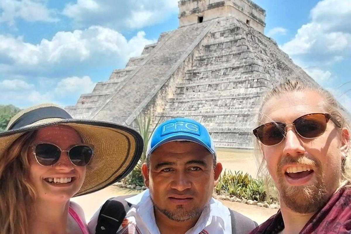 a group of people standing in front of the pyramid