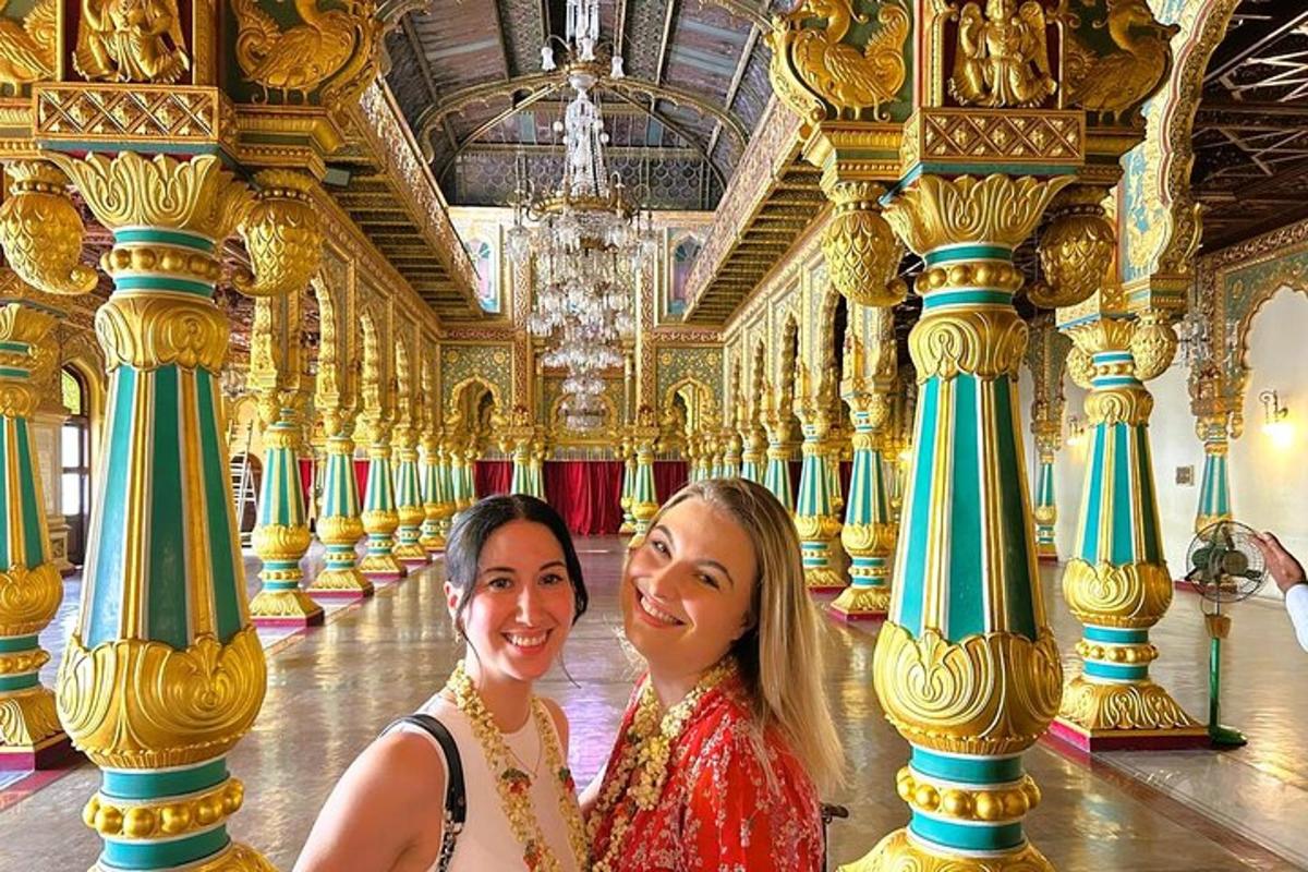two women standing in a room with columns