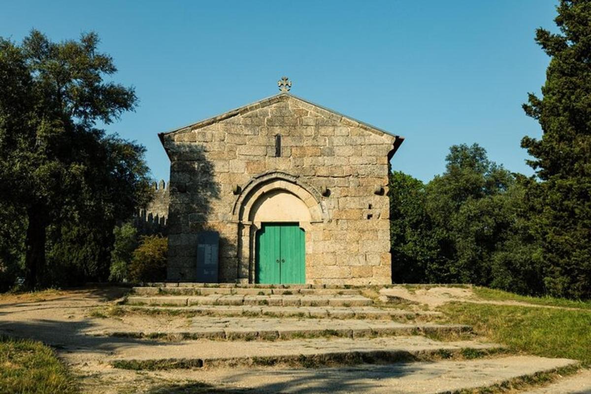 a small stone church with a green door