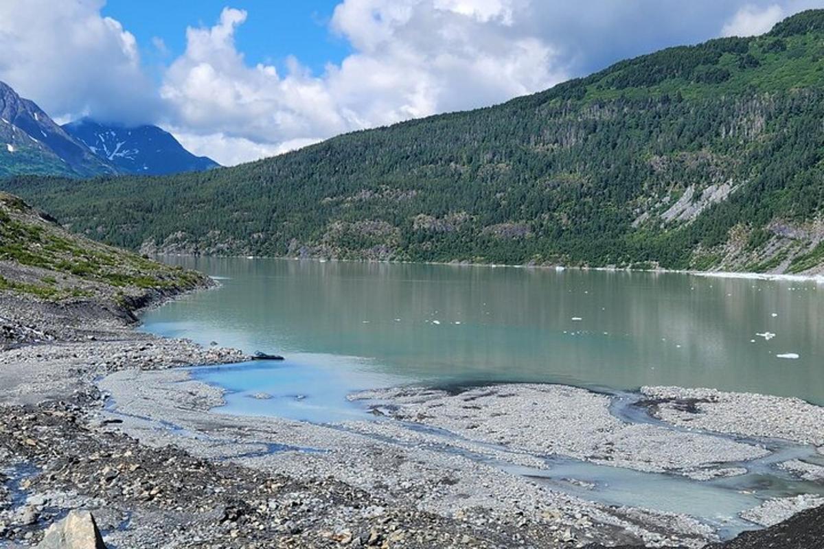 a large body of water with mountains in the background