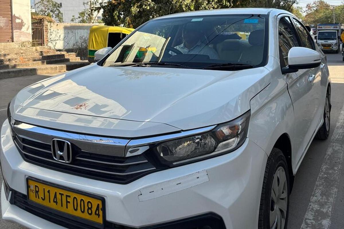 a white car parked on the side of a street
