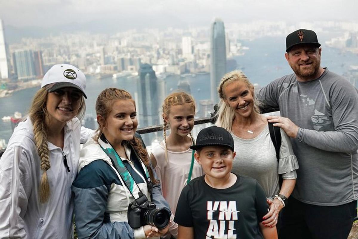 a group of people posing for a picture at the top of a mountain