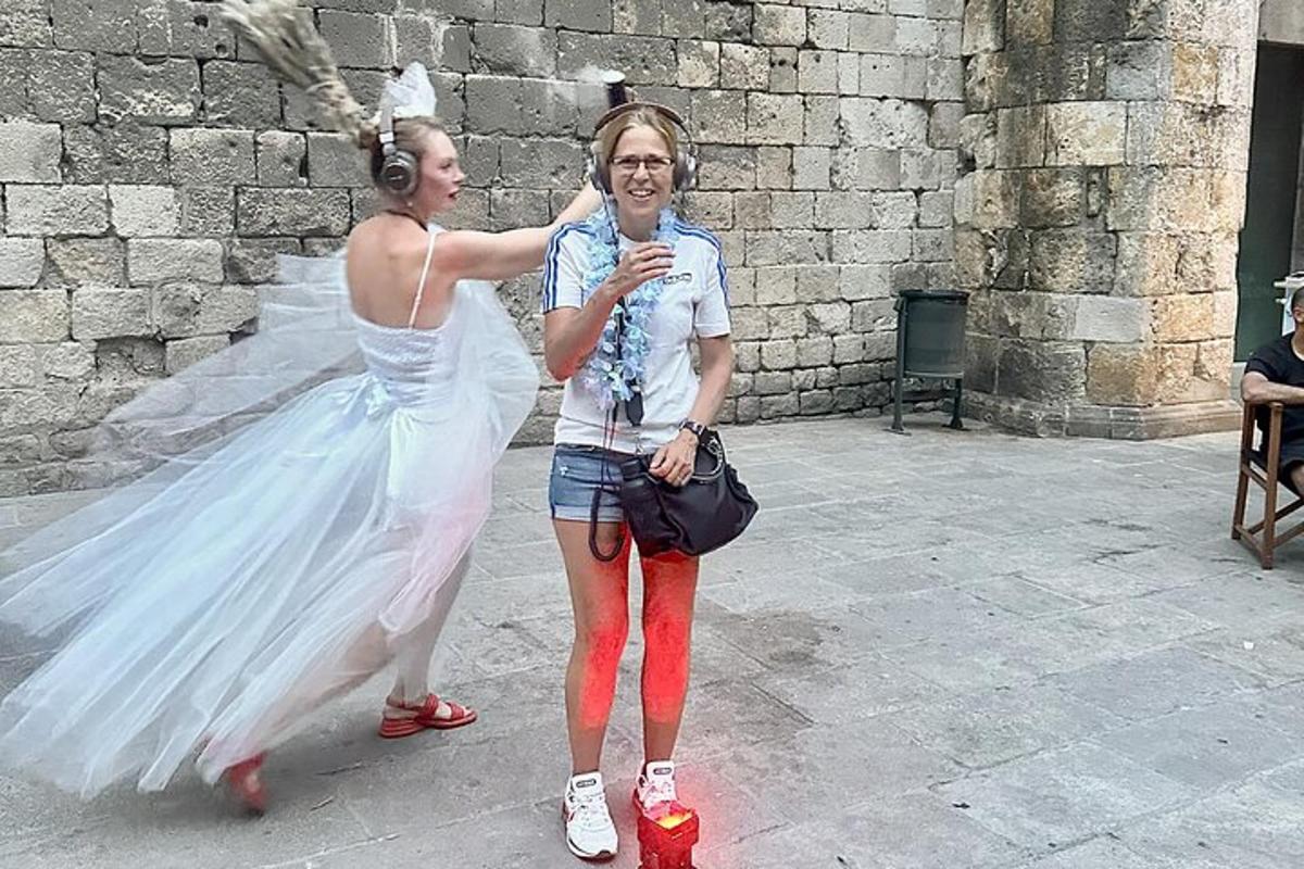 a woman in a wedding dress standing next to a girl