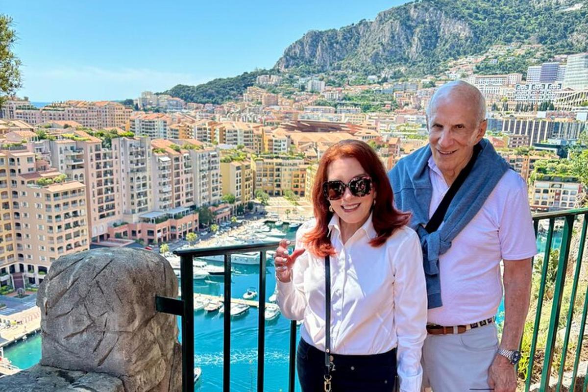 a man and a woman standing on top of a balcony
