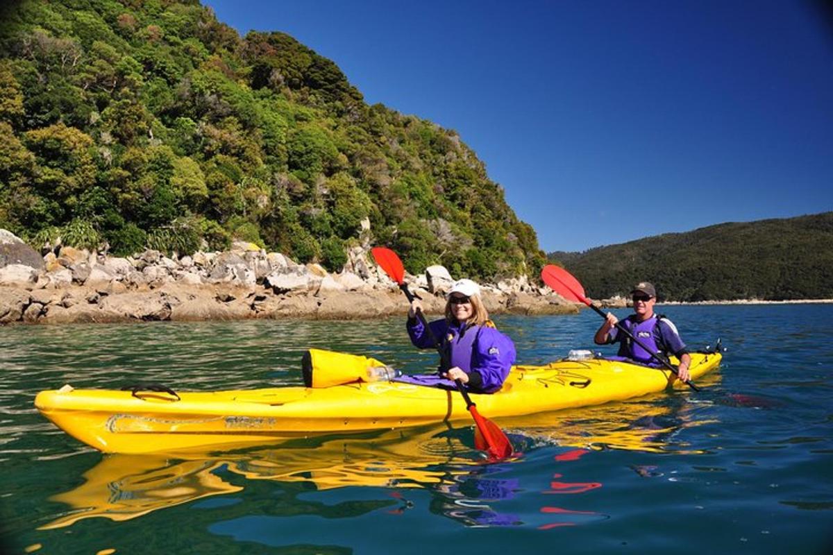 two people in a yellow kayak in the water