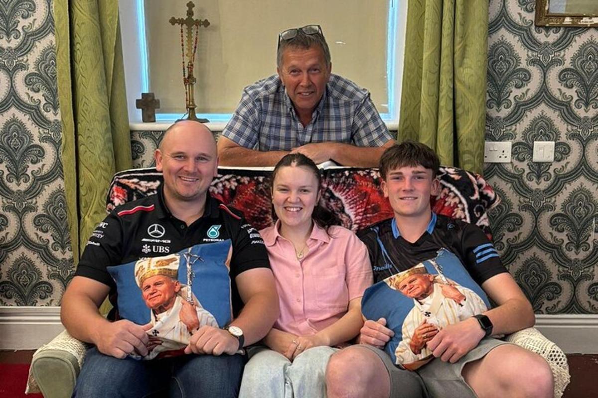 a group of people sitting on a bed with pictures of themselves