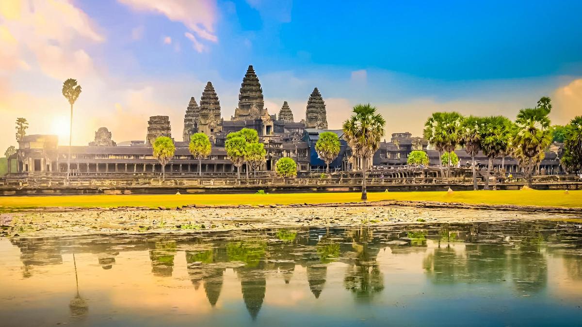 a view of a temple with trees and a body of water
