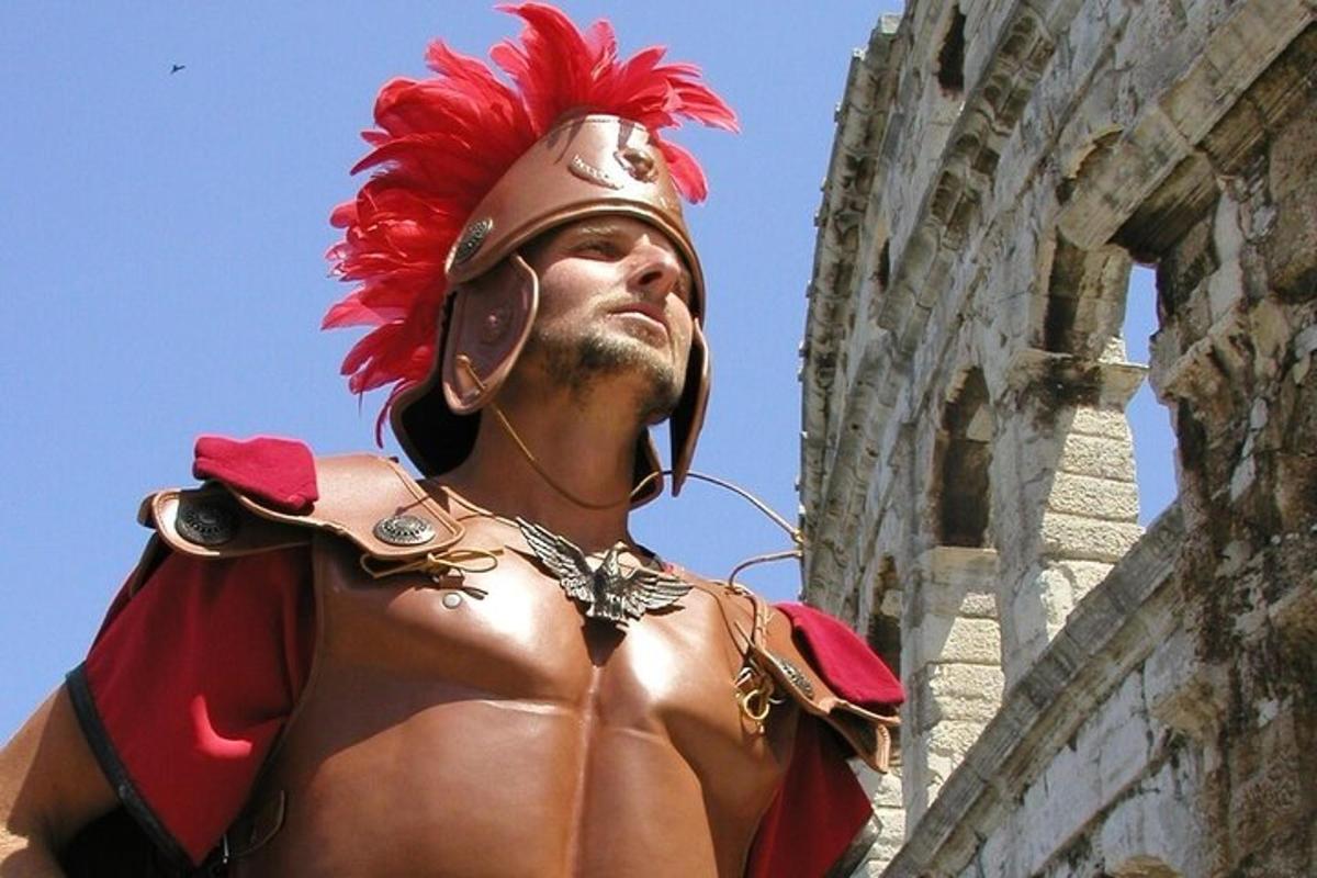 a man in an ancientreek outfit standing next to a building