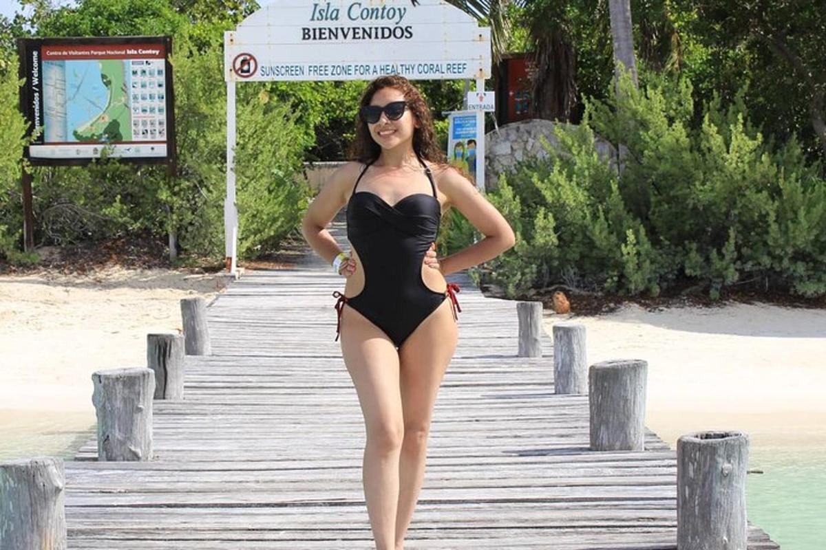 seorang wanita berbikini hitam berdiri di atas dok
