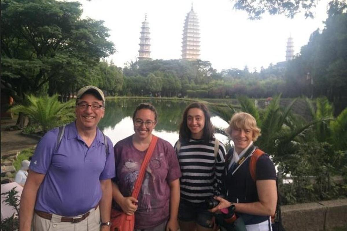a group of people posing for a picture in a park