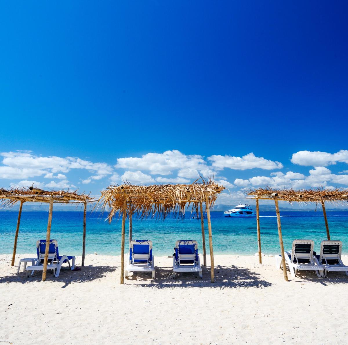 a group of chairs and umbrellas on a beach