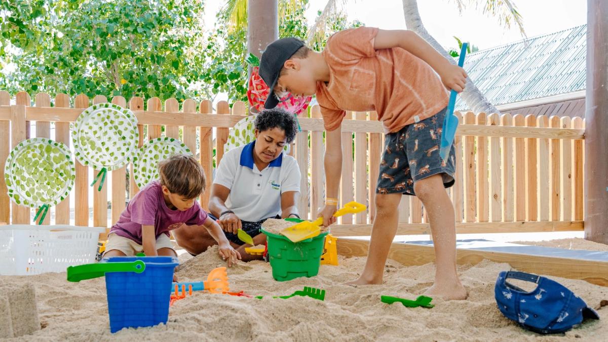 a group of children playing in the sand