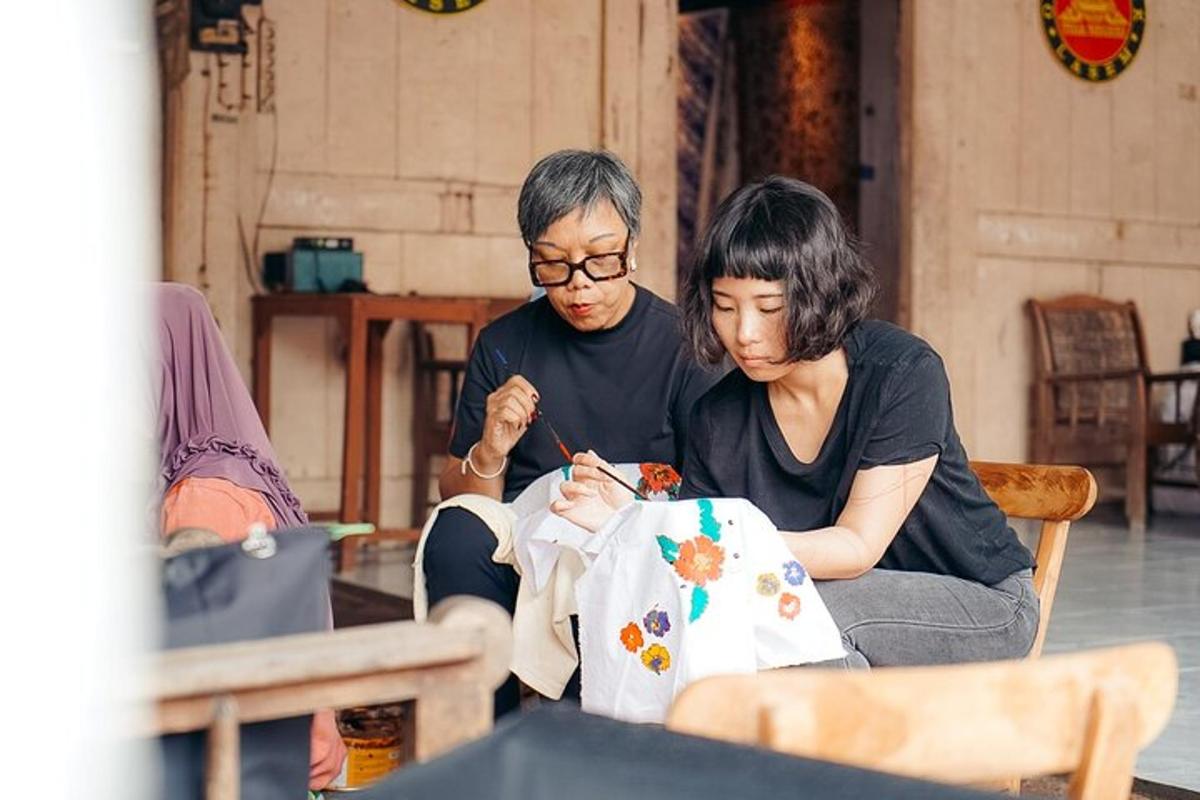 a man and a woman working on a piece of fabric