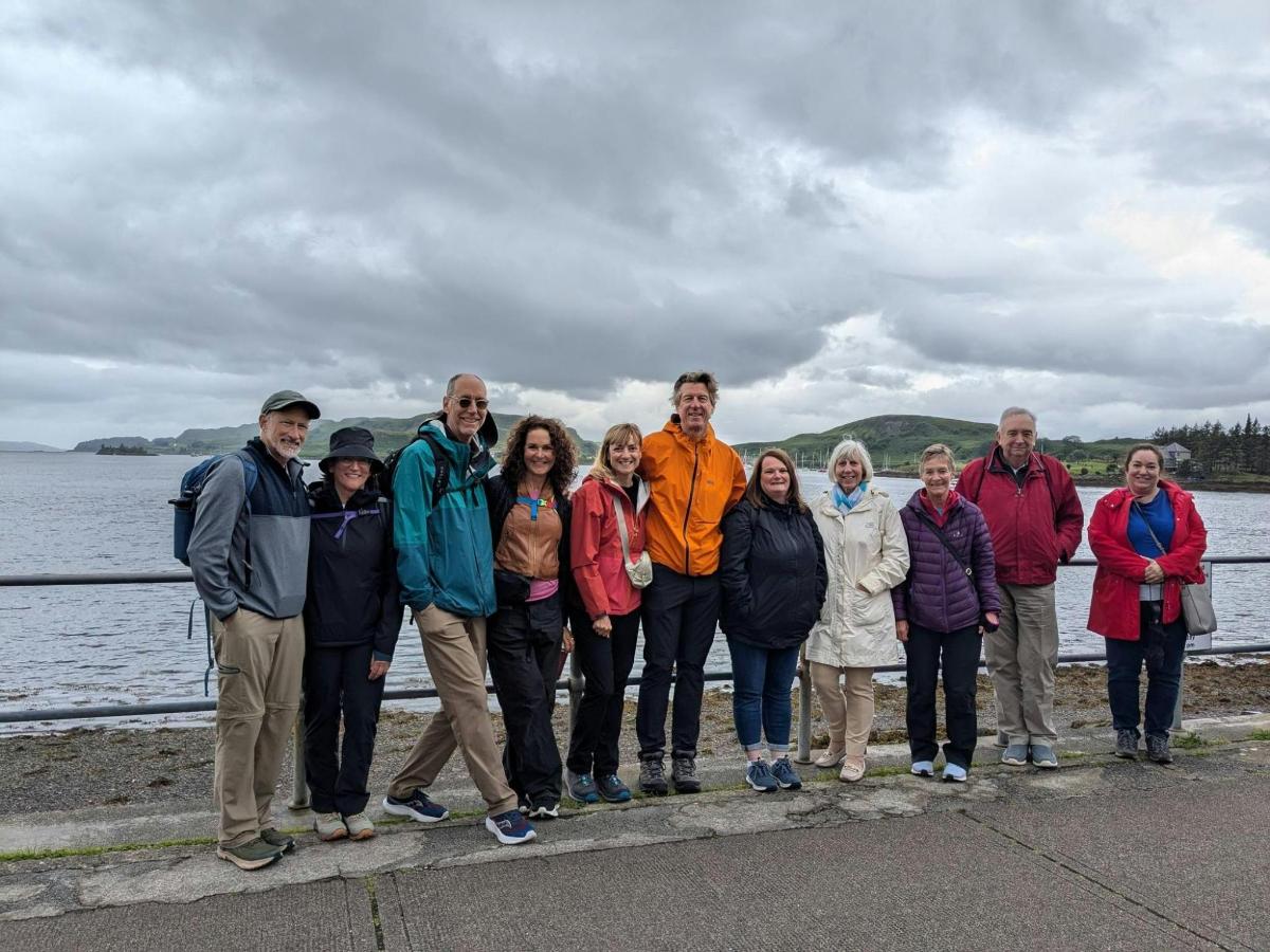 a group of people posing for a picture by the water