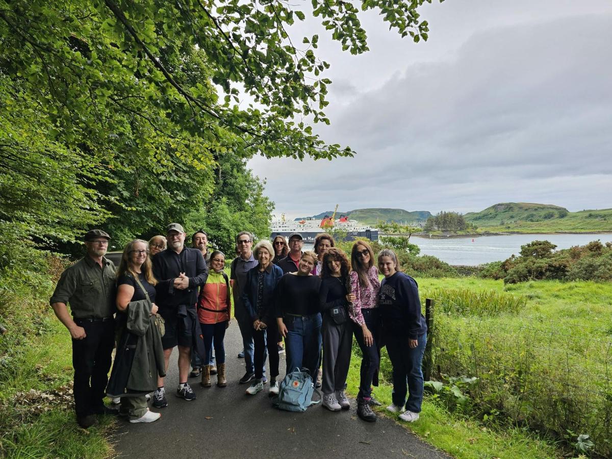 a group of people posing for a picture on a path by a lake