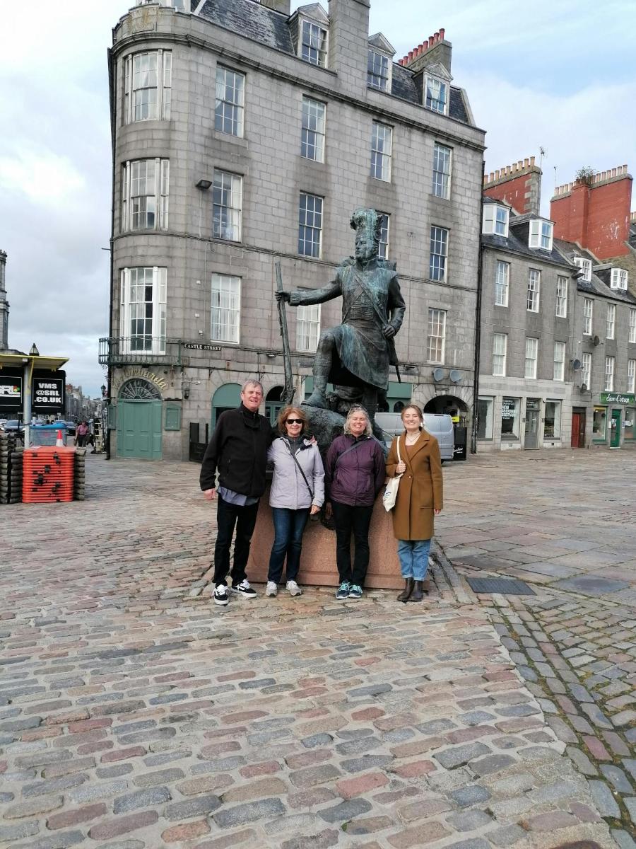 a group of people standing in front of a statue
