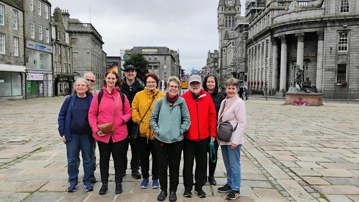 a group of people posing for a picture in a city
