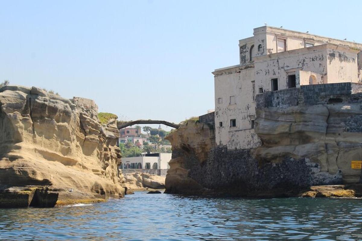 an old building on a cliff next to the water