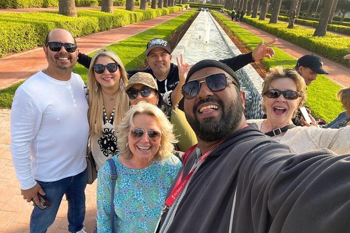 a group of people posing for a picture in front of a fountain