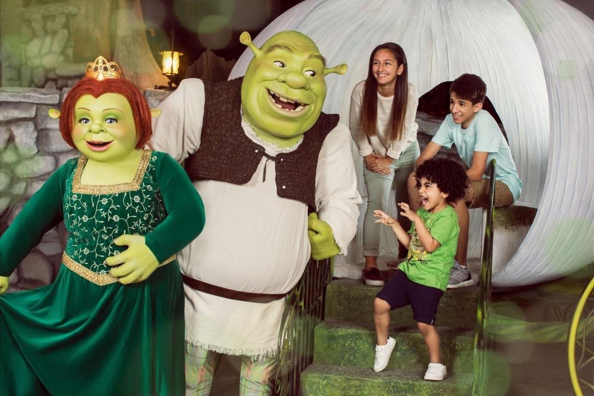 a group of children standing next to a man and a woman