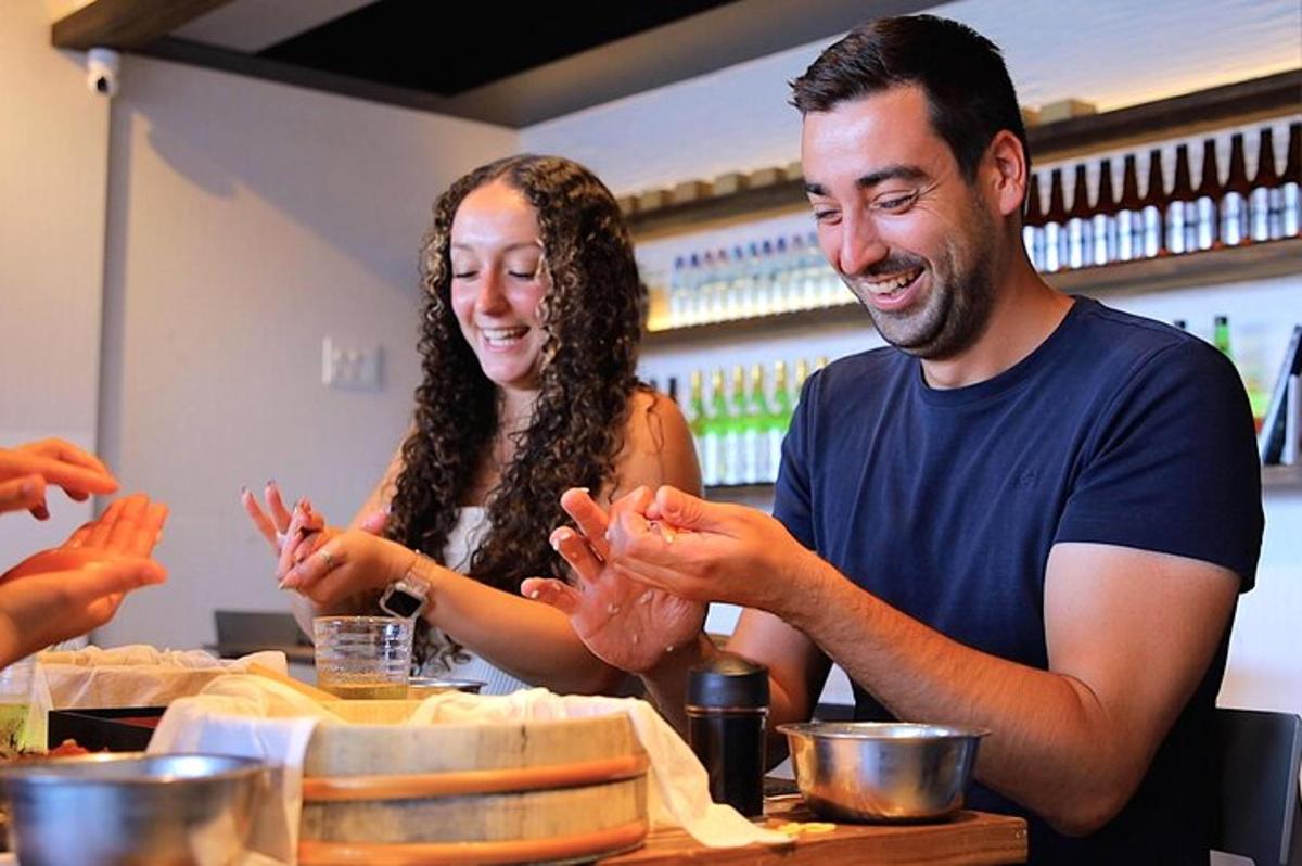 a man and a woman sitting at a table with their hands
