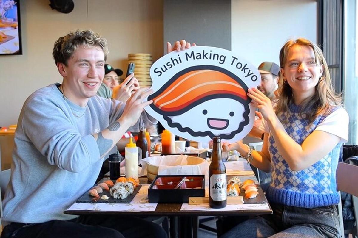 a man and woman sitting at a table with a cake