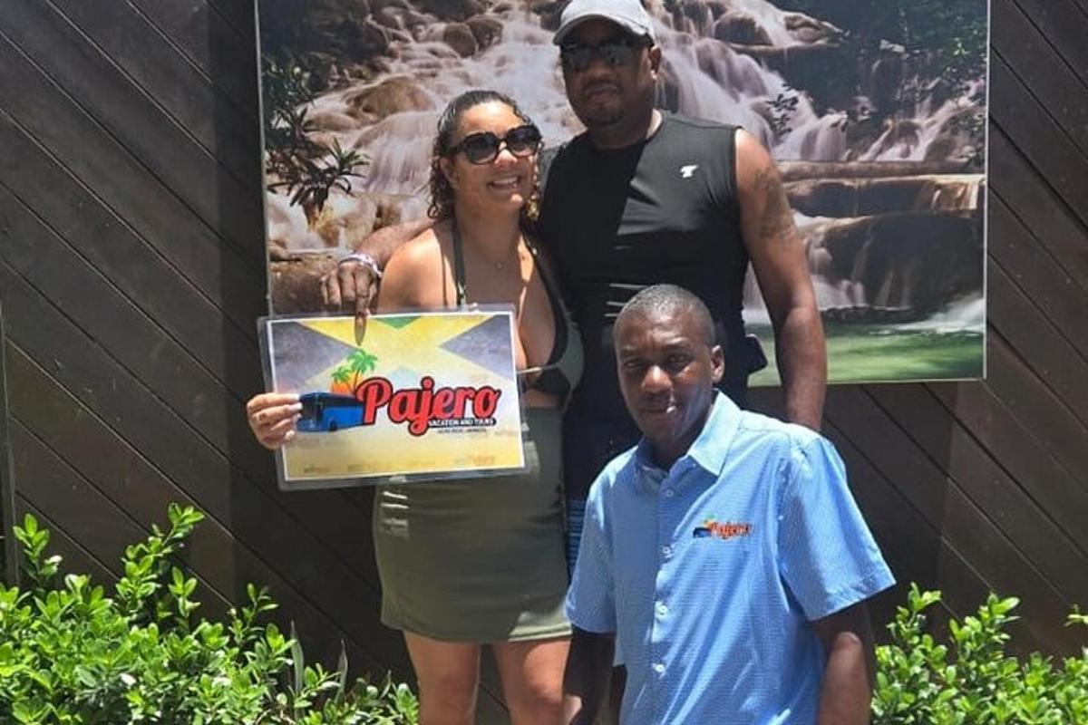 a man and a woman holding a box with a sign