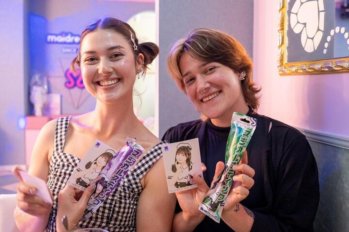 two women holding up toothbrushes in a room