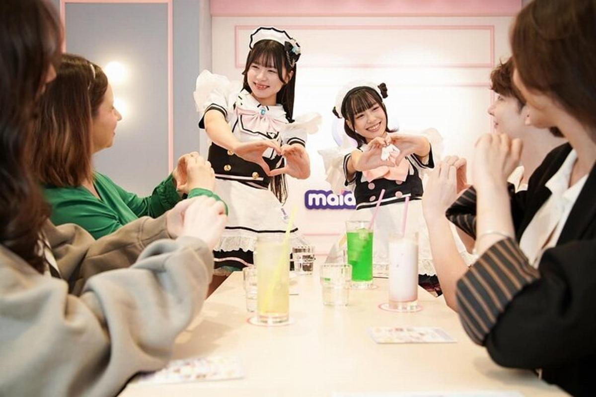 a group of women standing around a table with drinks