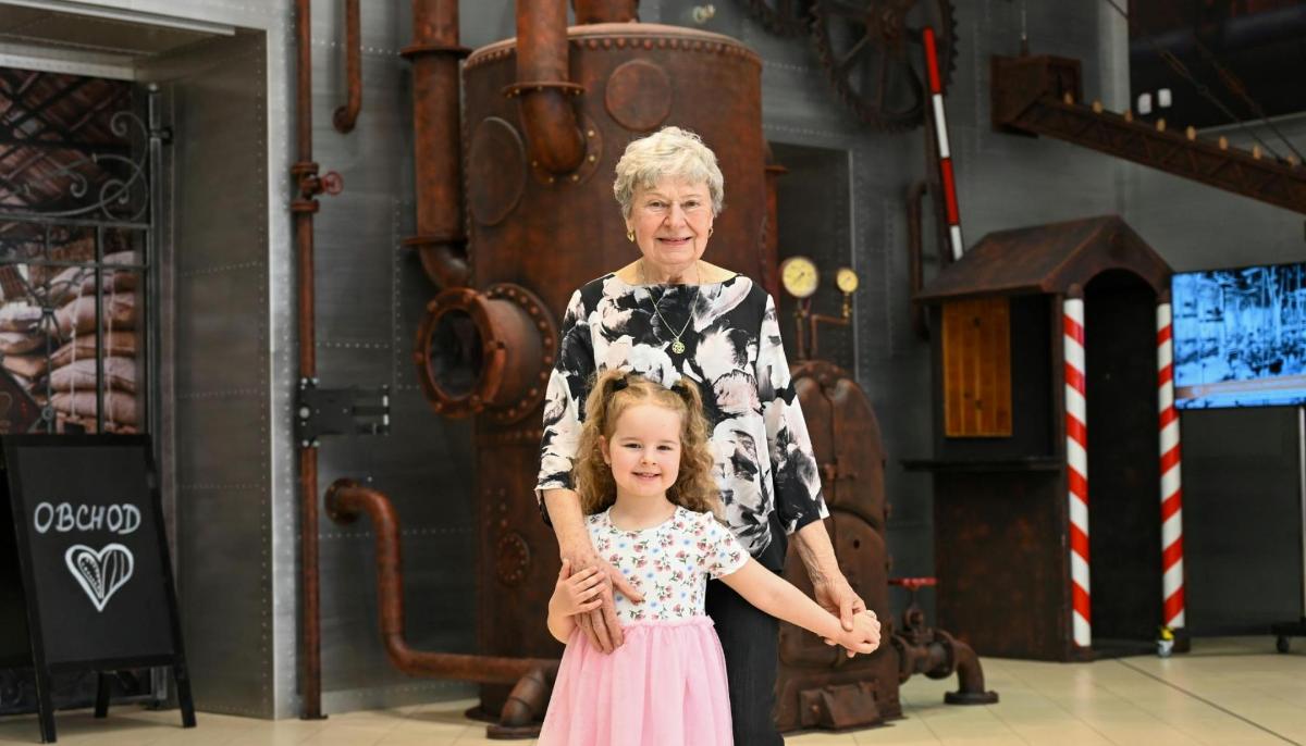 a woman and a little girl holding hands