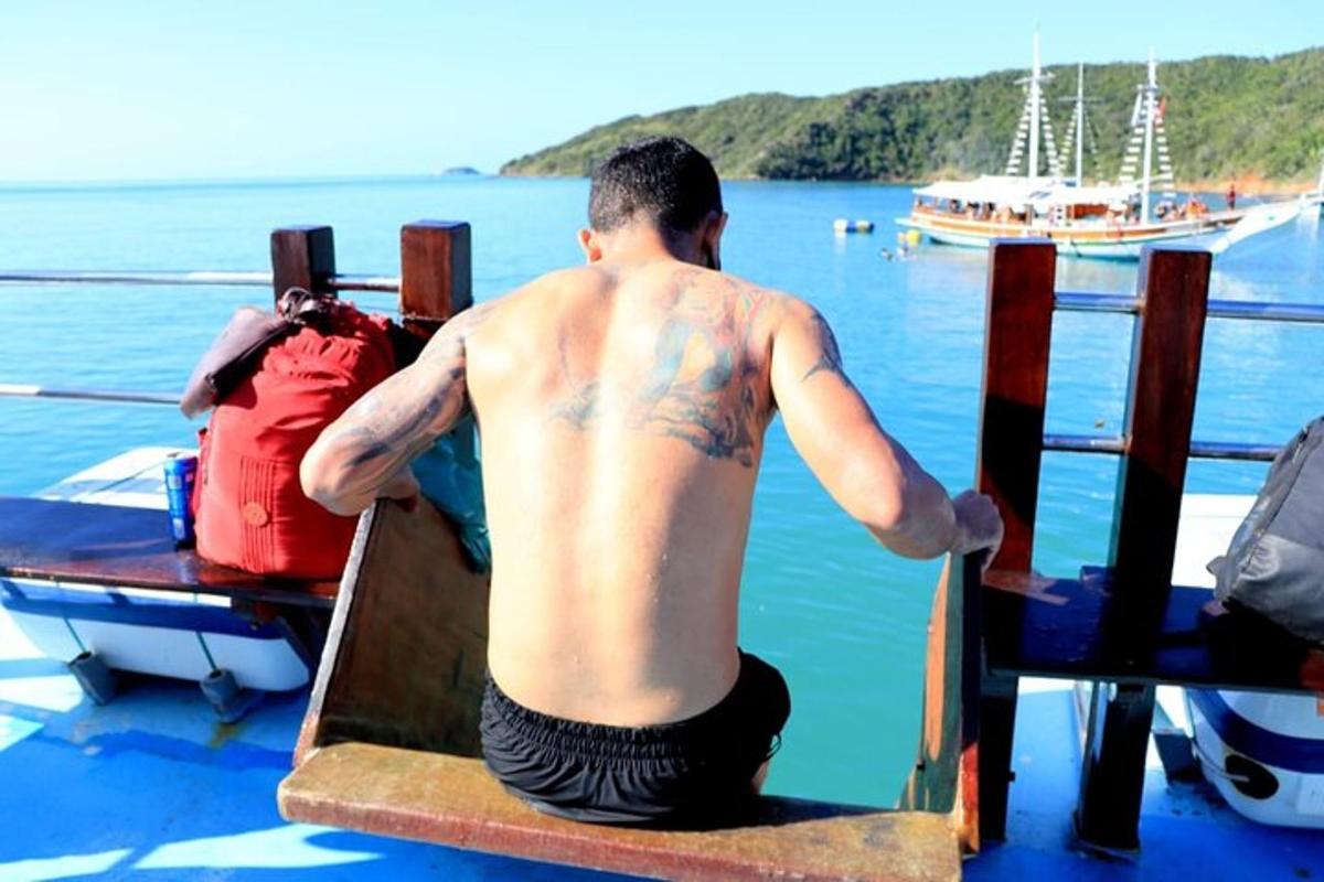 a man sitting on a boat in the water