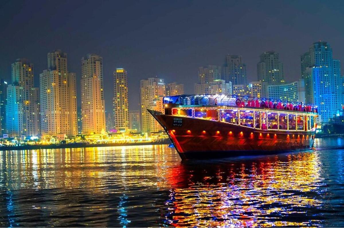 Un barco en el agua frente a una ciudad por la noche.