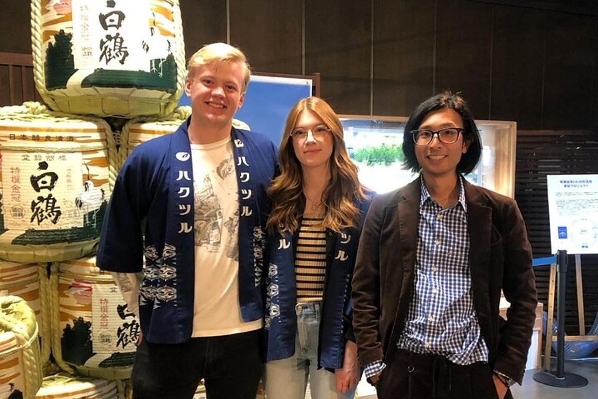 een groep van drie mensen die voor een winkel staan