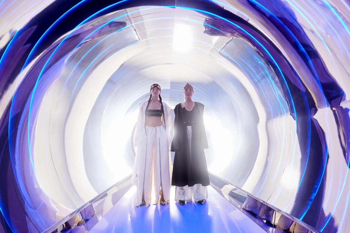 two women are standing in a tunnel
