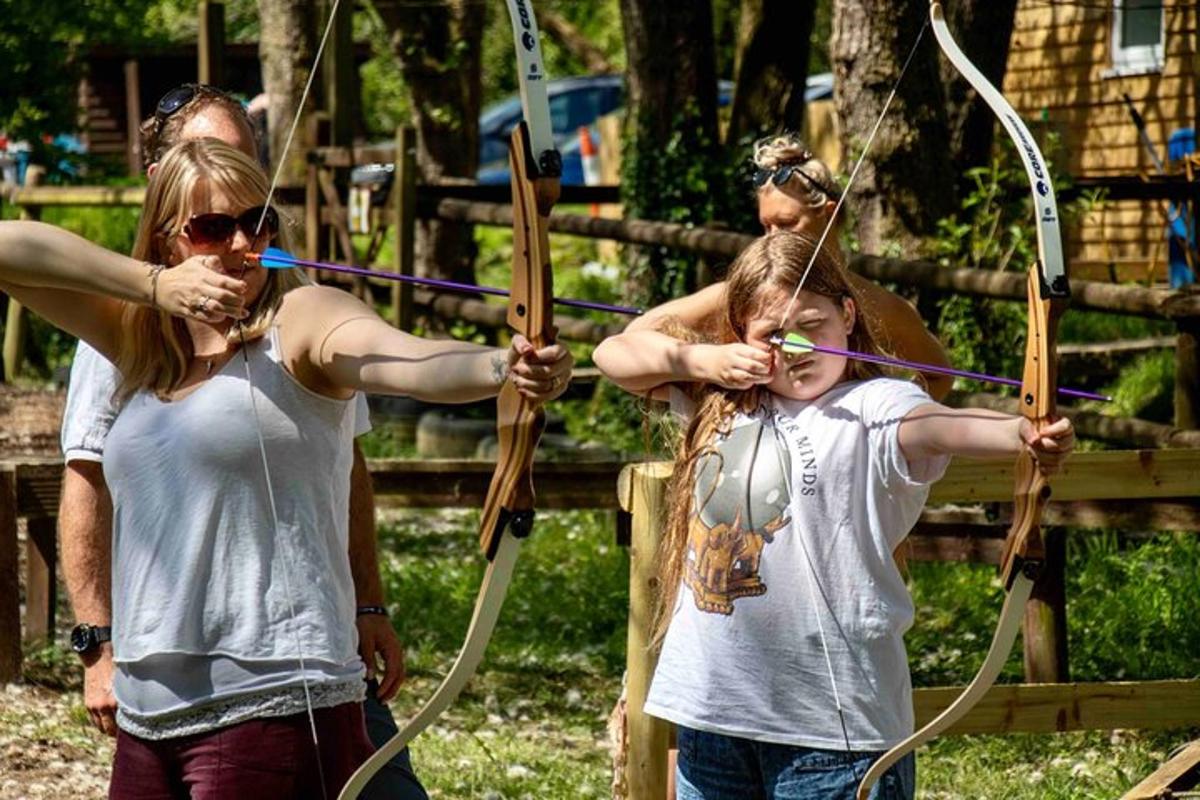 a man and a girl playing with a bow and arrow