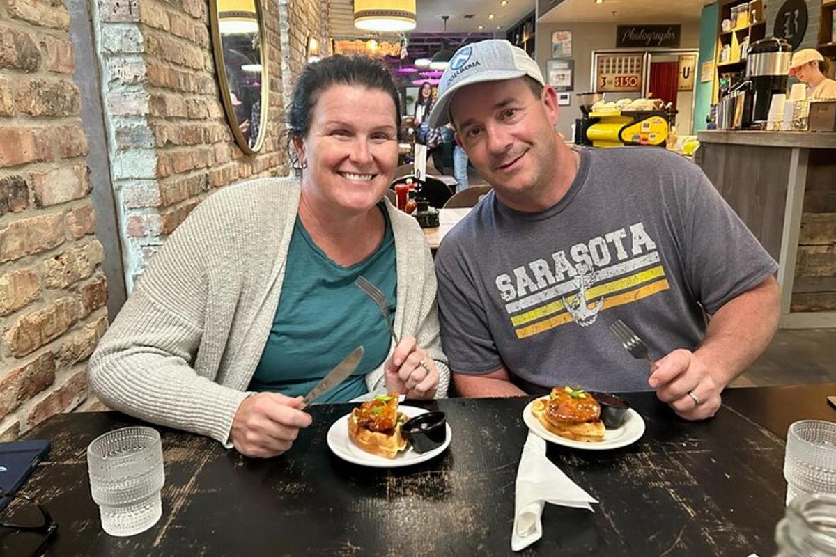 a man and a woman sitting at a table eating food