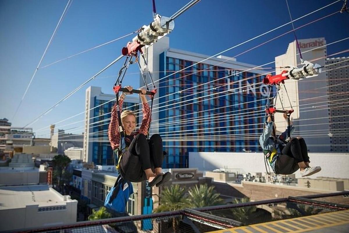 a man is riding on a zip line in a city