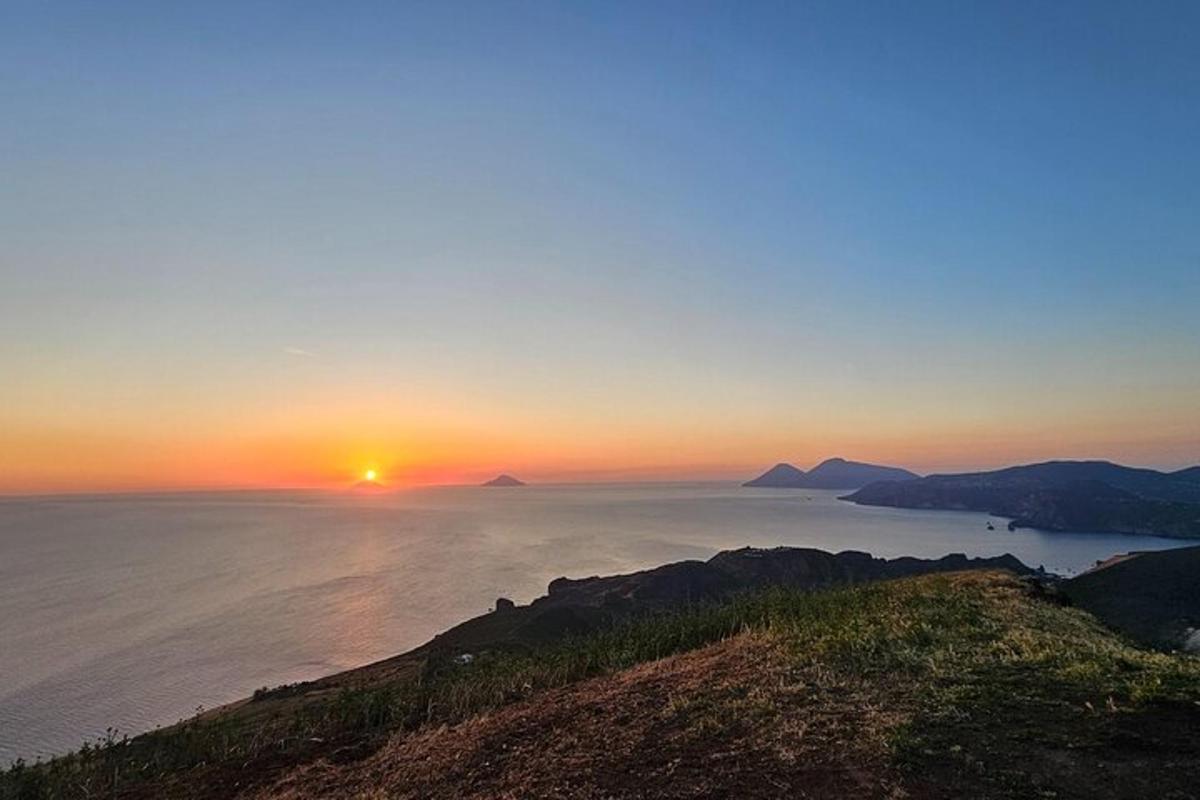 a sunset over the ocean with the sun in the sky