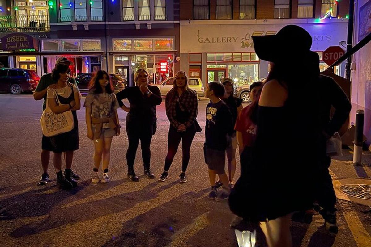 a group of people walking down a street at night