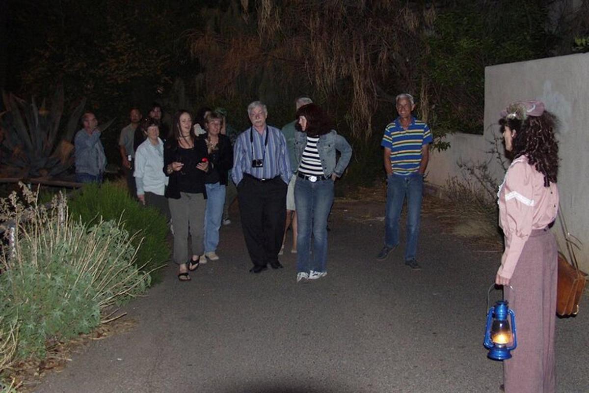 a group of people walking down a path at night
